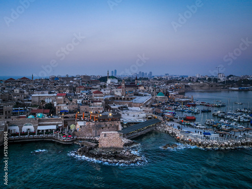 Acre (Akko) is a port city located on the Mediterranean coast and is known for its well-preserved ancient city fortifications. .Aerial footage of the old city, the ancient port and marina.