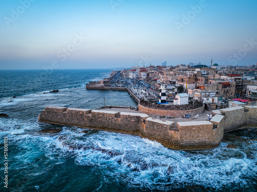 Acre (Akko) is a port city located on the Mediterranean coast and is known for its well-preserved ancient city fortifications. .Aerial footage of the old city, the ancient port and marina.
