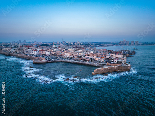 Acre (Akko) is a port city located on the Mediterranean coast and is known for its well-preserved ancient city fortifications. .Aerial footage of the old city, the ancient port and marina.