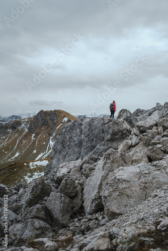 View of mountain landscape with women hiker in the foreground in the Allgäu Germany at autumn.