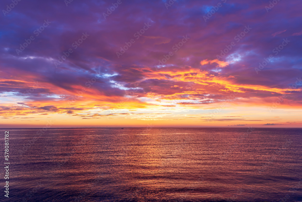 view at sunrise or sunset in sea with nice beach , surf , calm water and beautiful clouds on a background of a sea landscape view at sunrise or sunset in sea with nice beach , surf , calm water and beautiful clouds on a background of a sea landscape
