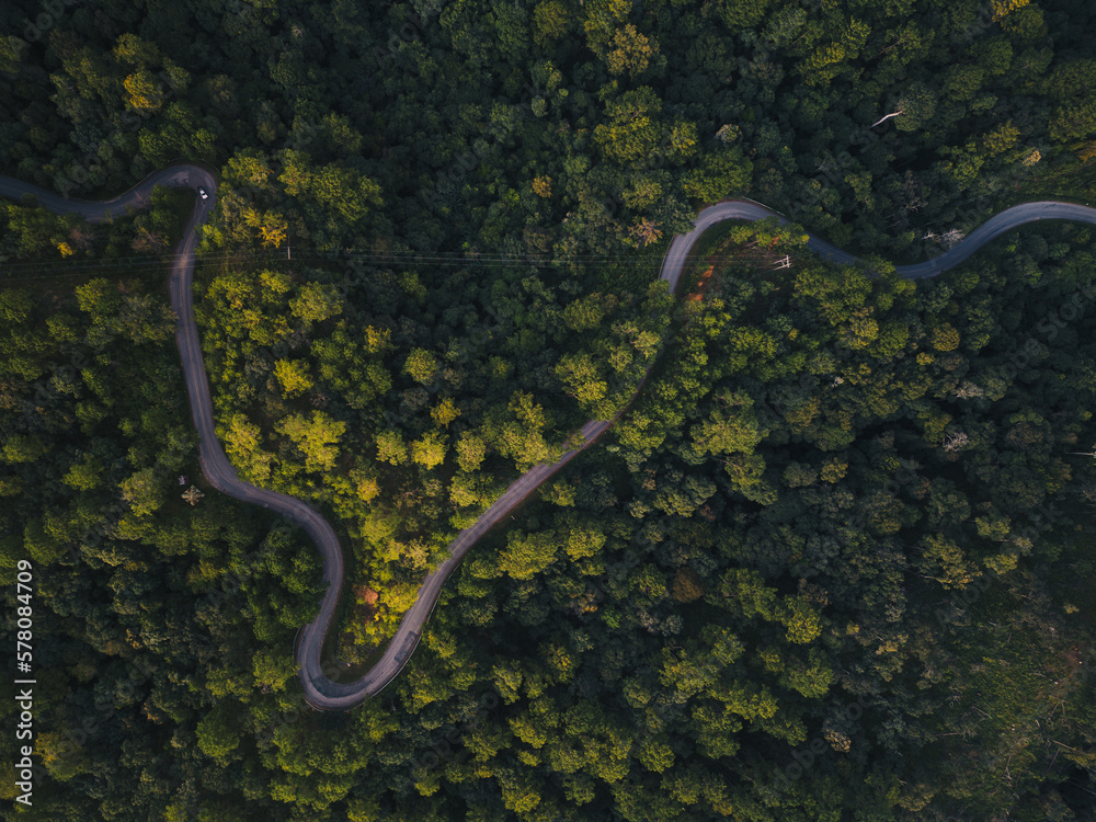 Aerial view of countryside road passing through the green forrest and mountain Aerial view of countryside road passing through the green forrest and mountain