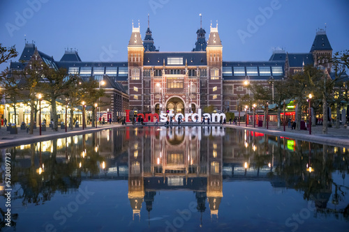 The Rijksmuseum building reflected in a pool, with the I amsterdam sign, in Amsterdam, Netherlands