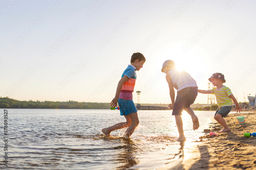 Cute kids having fun on the sandy beach in summer Cute kids having fun on the sandy beach in summer