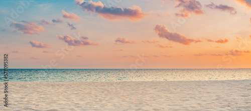 Closeup sea sand beach. Panoramic beach landscape. Inspire tropical beach seascape horizon. Orange and golden sunset sky calmness tranquil relaxing sunlight summer mood. Vacation travel holiday banner