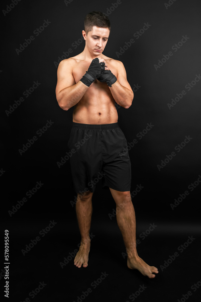 Boxer prepared for a sparring. Photo of muscular man isolated on black background. Strength and motivation.