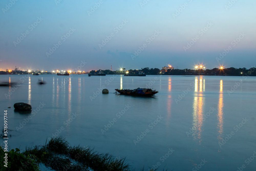 Boat in the river Ganges at Kolkata. Photo has been taken in Kolkata at West Bengal in beautiful blue light at evening.