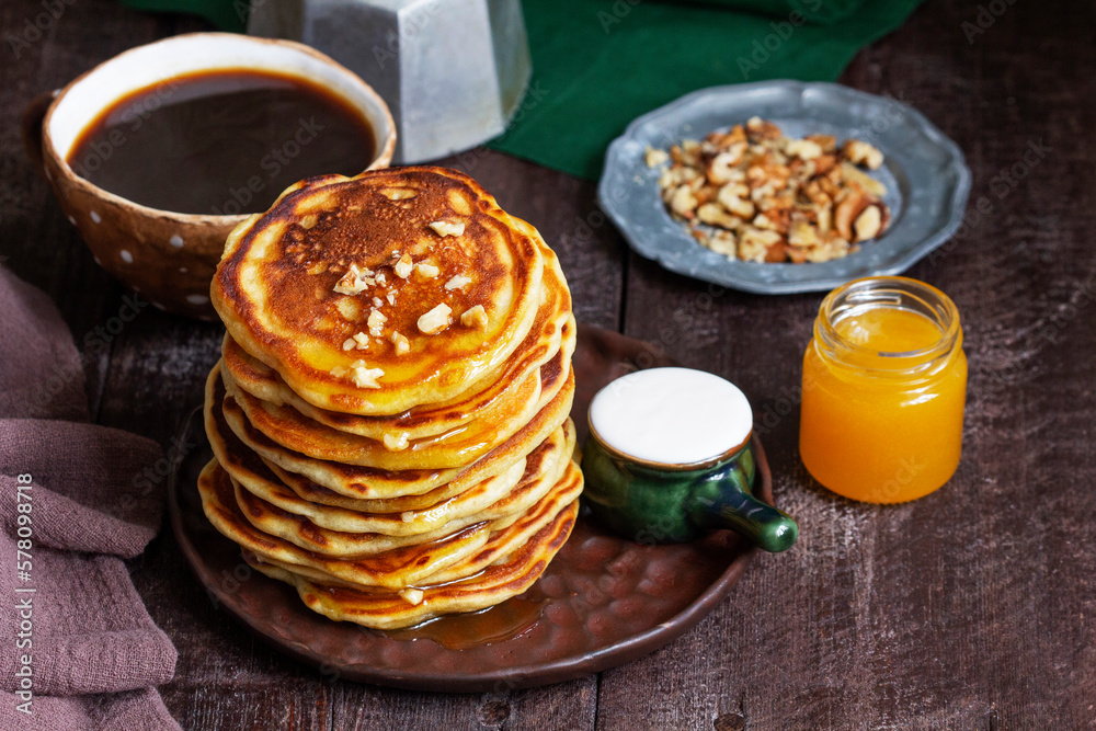 Apple pancakes served with honey, sour cream, nuts, tea and coffee.