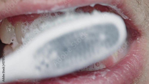 the process of using a toothbrush as a step in the daily procedure of brushing your teeth close-up