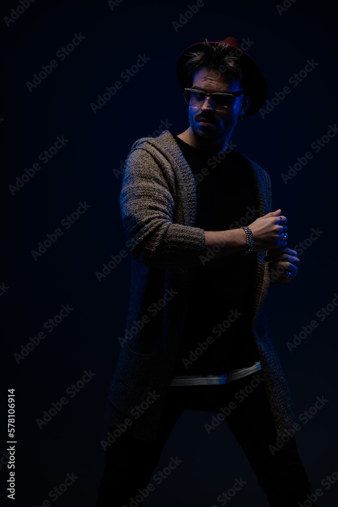 fashion man posing in a dramatic and mysterious vibe