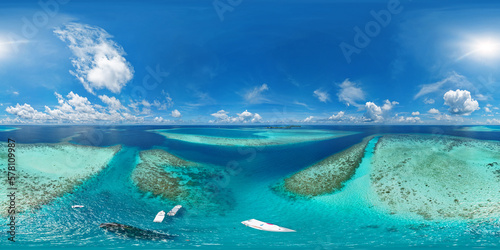 Panoramic view of Vaavu Atoll, near Keyodhoo, Maldives, where a shipwreck sticks out of the water. A place for tourists engaged in diving and snorkeling. Aerial seamless 360 degree spherical panorama © Sergey Chips