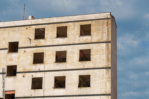 A ruined house with broken empty windows