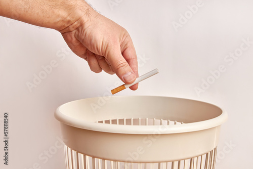 The cigarette is thrown into the trash. Disposal and recycling of plastic.