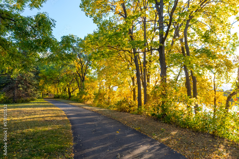 Beautiful park walking path along the Mississippi River in colorful fall autumn foliage Beautiful park walking path along the Mississippi River in colorful fall autumn foliage
