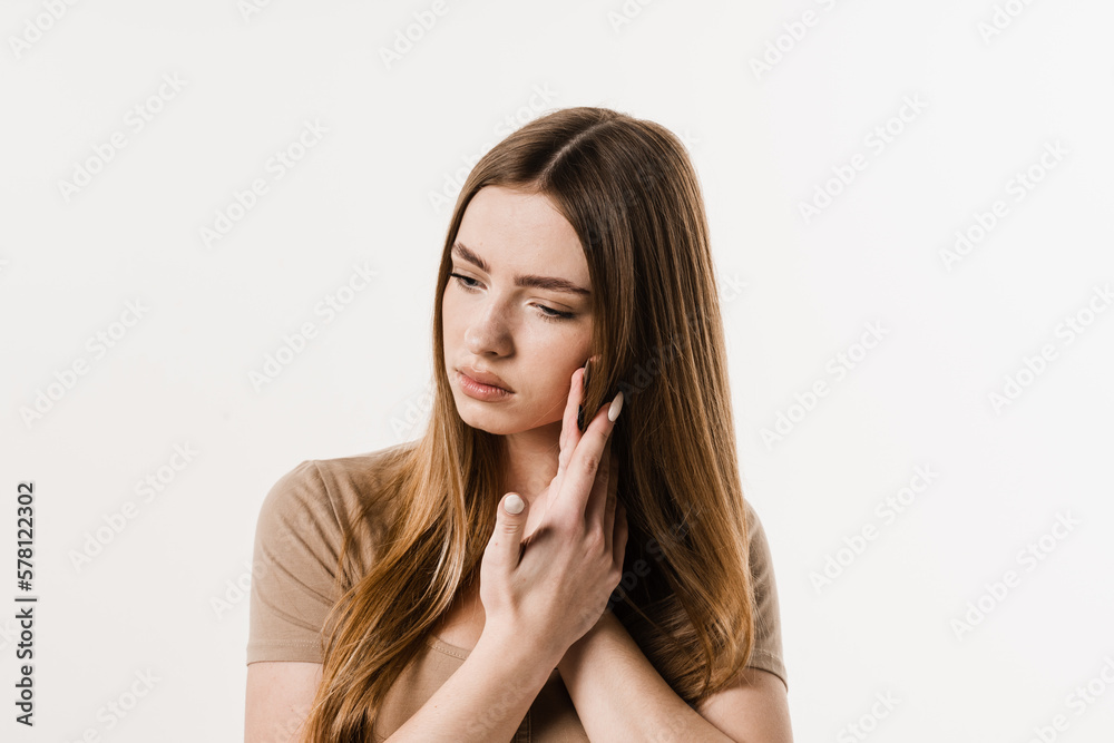 Girl is feeling toothache pain and discomfort of tooth. Girl with tooth decay, infection or injury to the tooth or gums on white background. Girl is feeling toothache pain and discomfort of tooth. Girl with tooth decay, infection or injury to the tooth or gums on white background.
