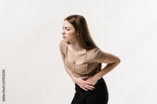 PID infection of one or more of the upper reproductive organs, including the uterus, fallopian tubes and ovaries. Girl with pelvic inflammatory disease on white background. © Rabizo Anatolii