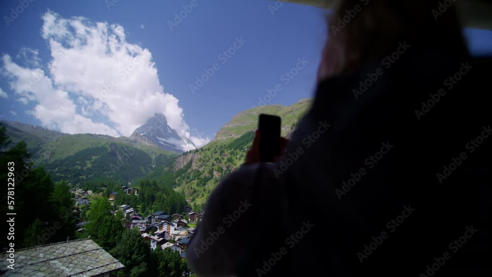 Zermatt female with smartphone hiking vacation picture Matterhorn Zermatt female with smartphone hiking vacation picture Matterhorn