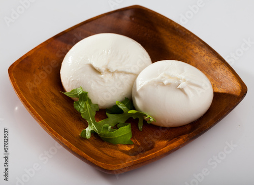 Image of burrata italian white cheese and arugula leaf closeup