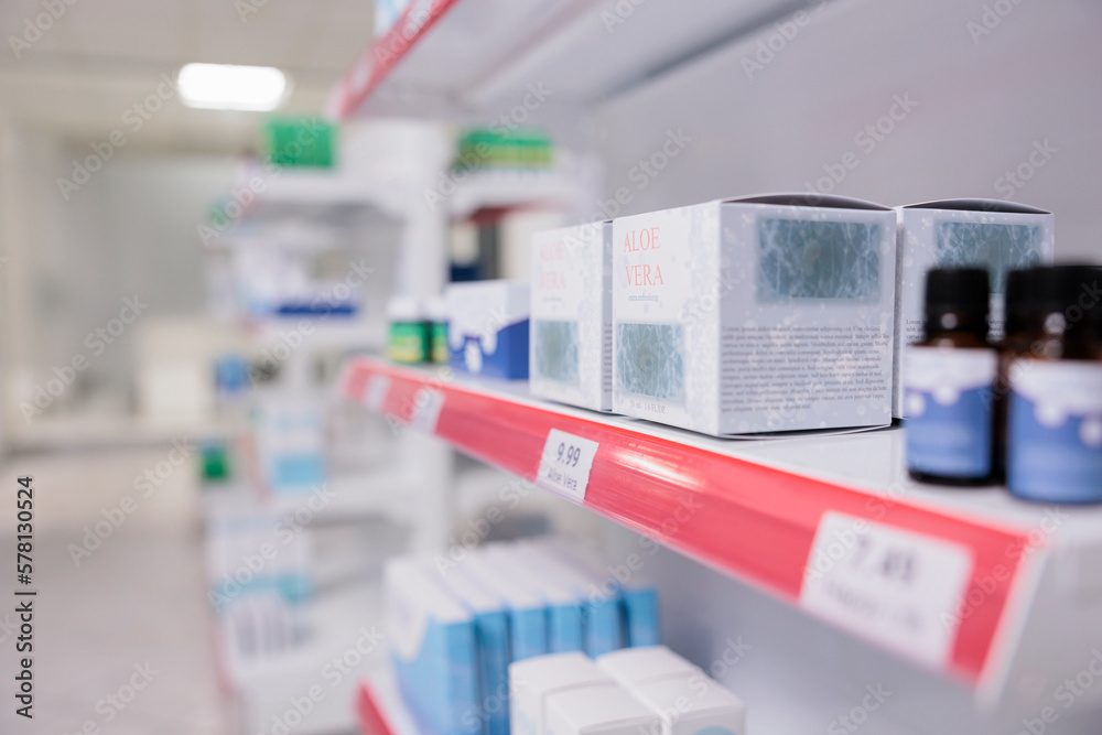 Healthcare retail store shelves stocked with various medicinal products and aloe vera cream ready for customers to come and buy during checkup visit in pharmacy. Medicine support service and concept