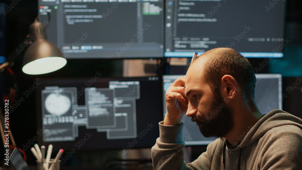 Thoughtful IT engineer brainstorming ideas in office, programming ...