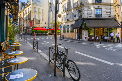 Fototapeta Naklejka Na Ścianę i Meble -  Cozy street with tables of cafe  in Paris, France