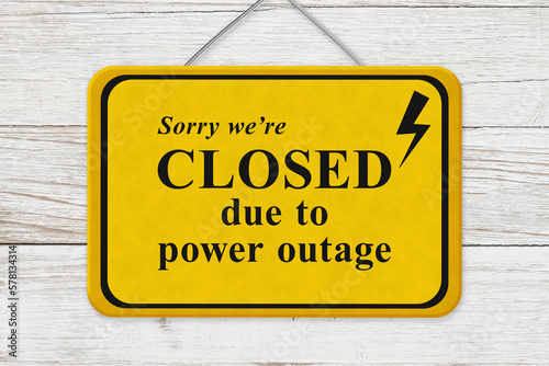 Closed due to power outage message yellow warning sign