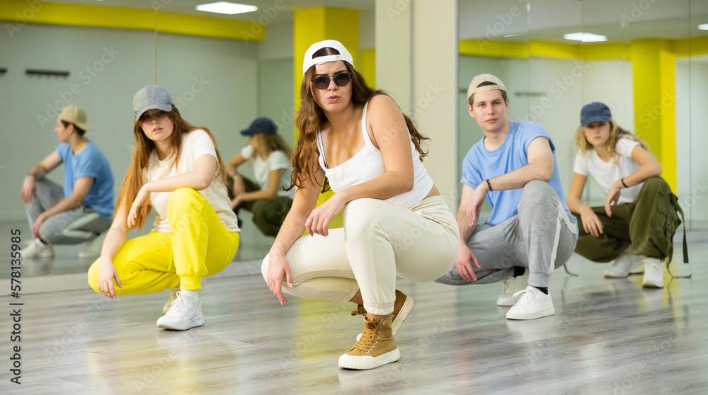 Fototapeta premium Young girl in sunglasses dancing modern dances in dance studio