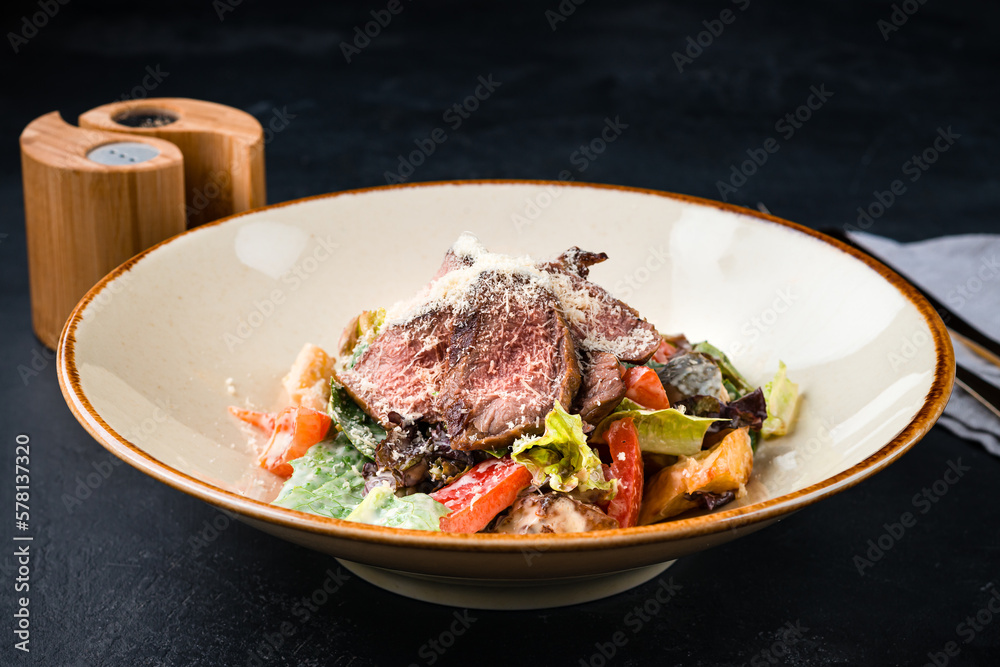 Beef salad with tomatoes, parmesan cheese, pickled cucumber, lettuce and sauce. Beef salad with tomatoes, parmesan cheese, pickled cucumber, lettuce and sauce.