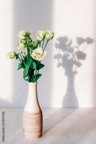 Bouquet of estouma flowers in vase in sunlight