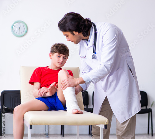 Leg injured boy visiting young doctor traumatologist