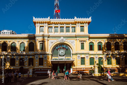 View of Saigon Central Post Office in Ho Chi Minh City, Vietnam with clear blue sky.