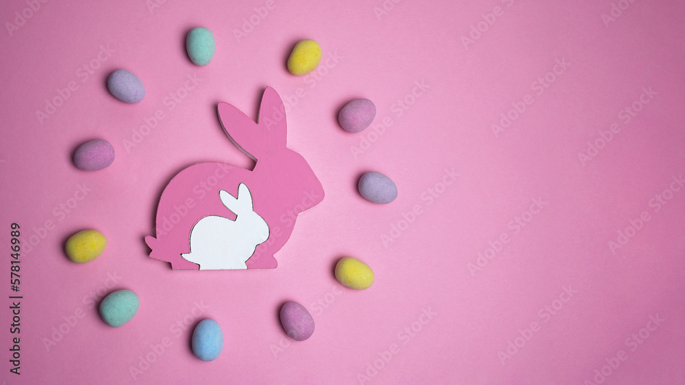 Creative easter layout made of colorful eggs as circle wreath with easter bunny on pink background. Happy Easter concept. Flat lay, copy space Creative easter layout made of colorful eggs as circle wreath with easter bunny on pink background. Happy Easter concept. Flat lay, copy space