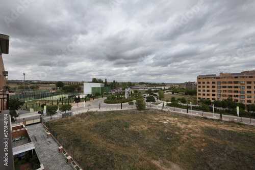 Panoramic views of a residential development with vacant lots on a rain cloud laden winter day