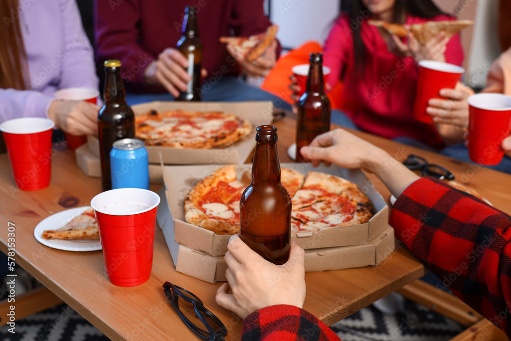 Group of friends with tasty pizza and drinks at home, closeup Group of friends with tasty pizza and drinks at home, closeup