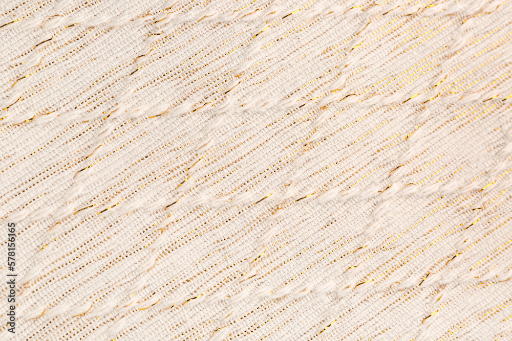 Fototapeta premium Elegant cream fabric texture with golden threads and diagonal weave pattern, textile background for design and decor