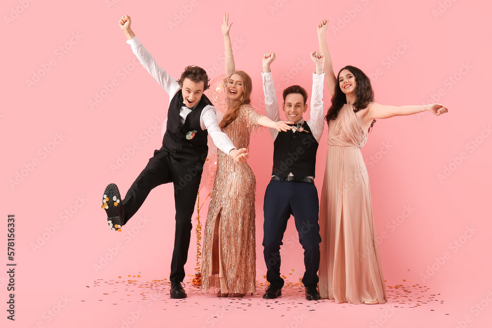 Beautiful couples dressed for prom on pink background - obrazy, fototapety, plakaty 