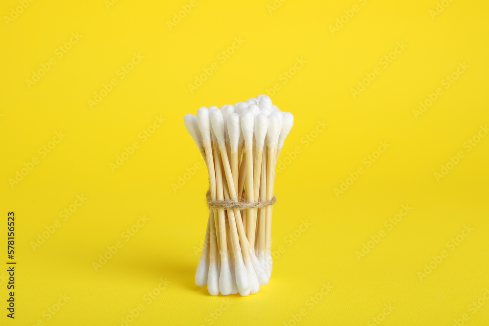 Bunch of new cotton buds on yellow background Bunch of new cotton buds on yellow background