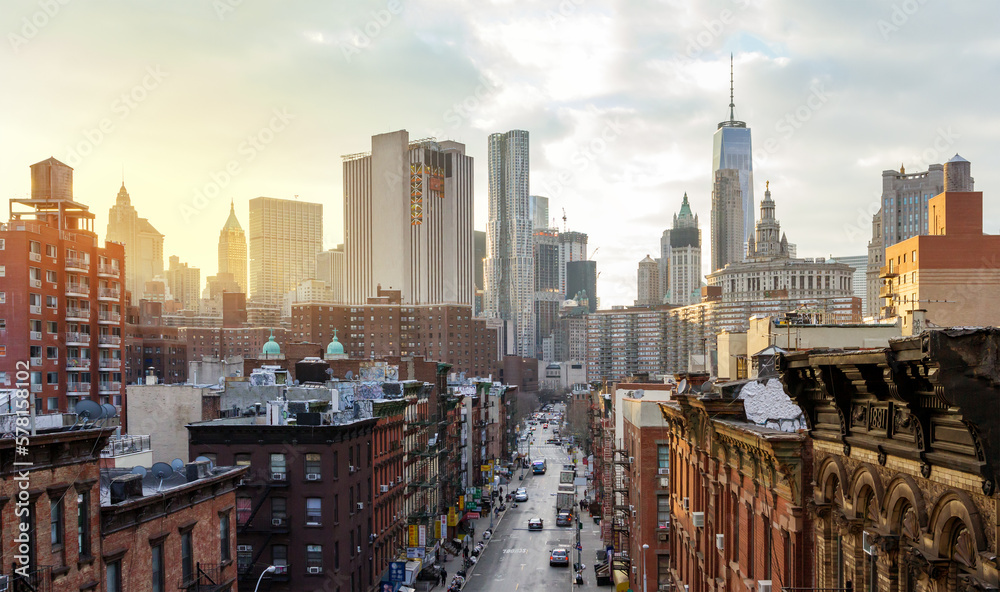 Overhead view of Madison Street in the Chinatown neighborhood of Manhattan with the downtown skyline buildings of New York City in background - obrazy, fototapety, plakaty 