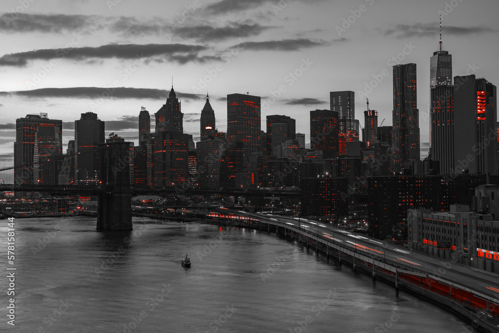New York City skyline buildings of Manhattan with red lights in black and white cityscape at night