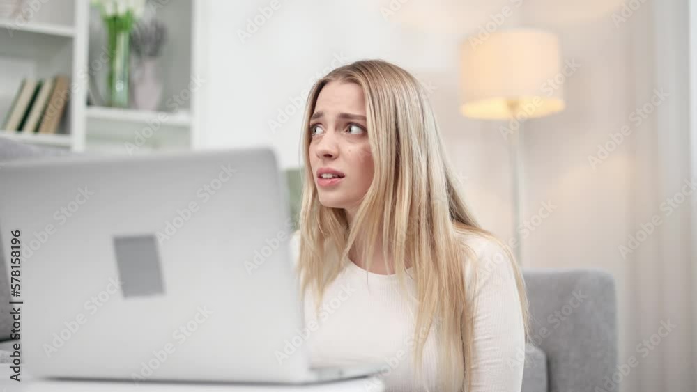 Sad young blond woman talk with psychotherapist at online distance remote counselling session indoors Depressed girl discussing problem with psychological support by laptop computer at home Sad young blond woman talk with psychotherapist at online distance remote counselling session indoors Depressed girl discussing problem with psychological support by laptop computer at home