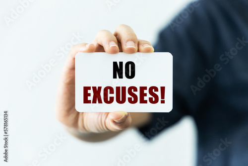 Fotografie No excuses on blank business card being held by a woman's hand with blurred background
