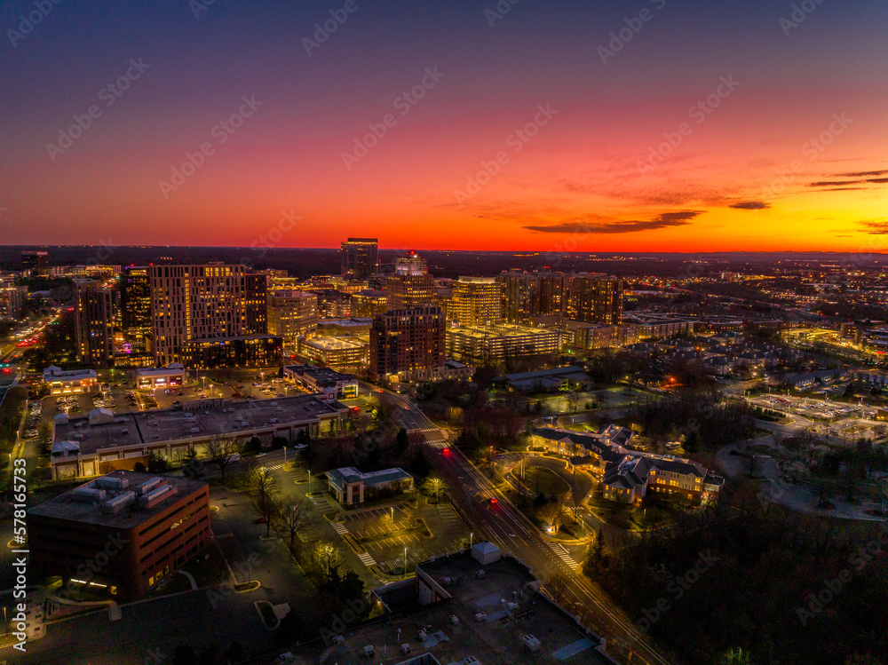 Colorful red, orange, yellow sunset sky over Reston town business center in Virginia