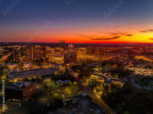 Colorful red, orange, yellow sunset sky over Reston town business center in Virginia