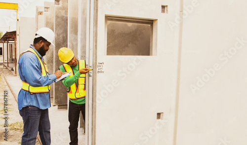 Canvas Print African American foremen and male workers large industrial plants produce precast walls