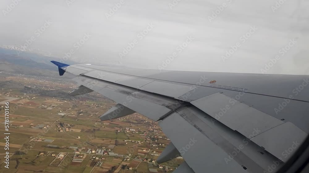 The wing of a passenger plane in flight. Airplane wing shot from the inside The wing of a passenger plane in flight. Airplane wing shot from the inside