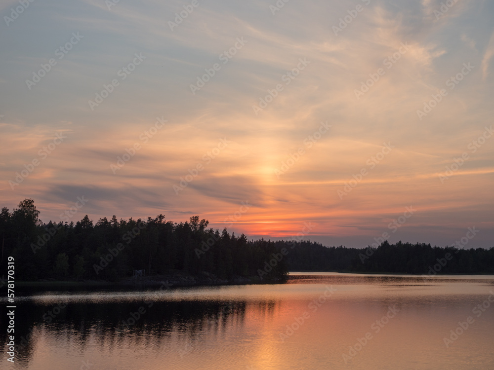 setting sun over the forest lake