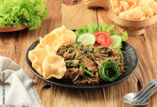 Lotek Bandung, Sundanese Traditional Healthy Salad Made from Various Boiled vegetable with Spicy Peanut Sauce. Usually Served wuth kerupuk and Eat with Steamed Rice photo