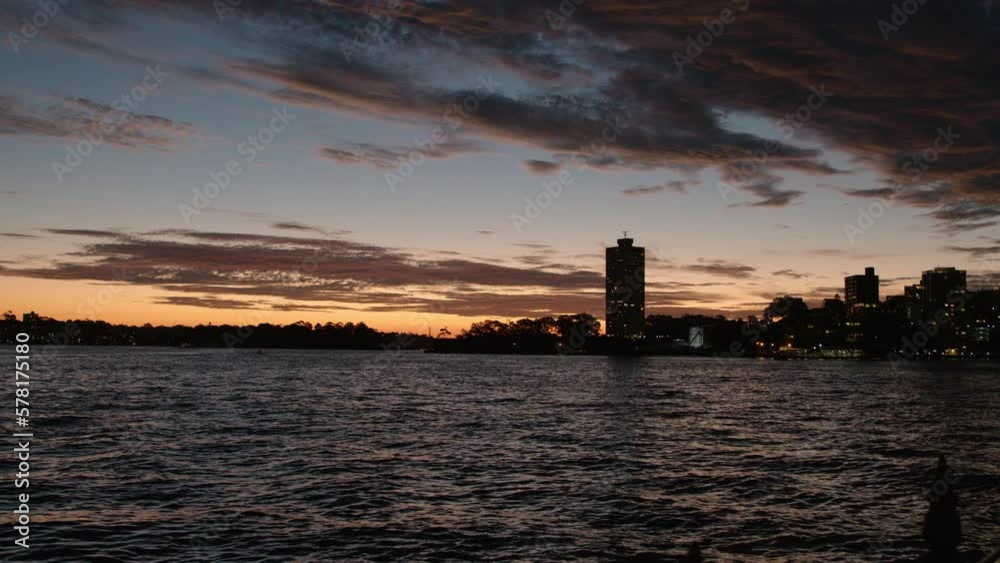 Quick pan down view from a dramatic sky to a reflecting and silhouetted harbour. Quick pan down view from a dramatic sky to a reflecting and silhouetted harbour.
