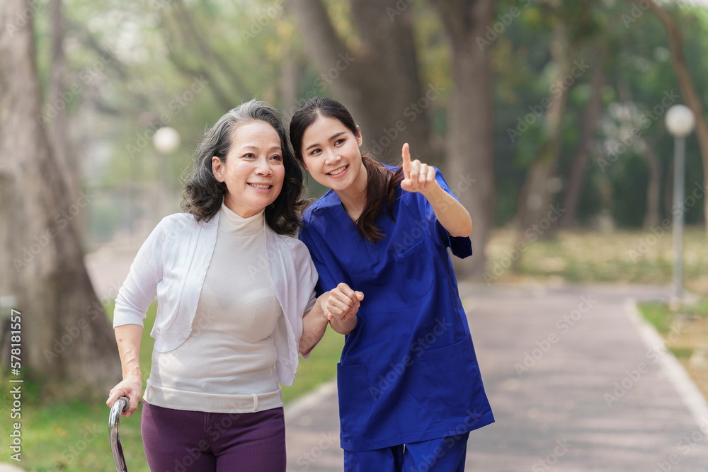 Healthcare nurse, physical therapy with elderly woman at outdoor. Nurse holding hand and help elderly woman walking Healthcare nurse, physical therapy with elderly woman at outdoor. Nurse holding hand and help elderly woman walking