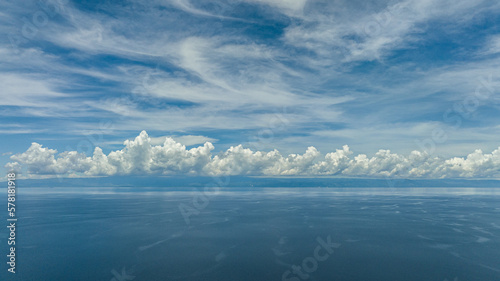 View of the island of Cebu from the sea. Blue ocean and sky with clouds. Seascape in the tropics.